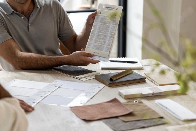 Hunter Douglas fabric sample books spread across a table during a design consultation