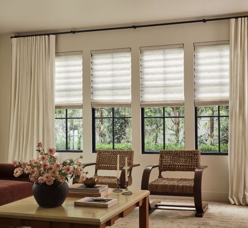 Roman shades paired with existing drapery panels   layered, not crowded.