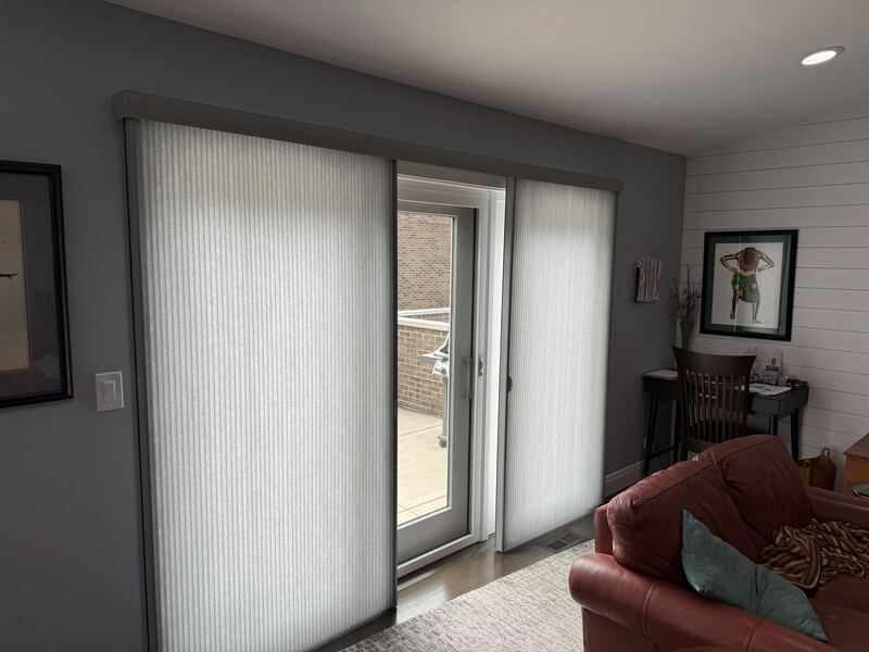 The same installation seen wider   the door panel and the adjacent window read as one continuous treatment.