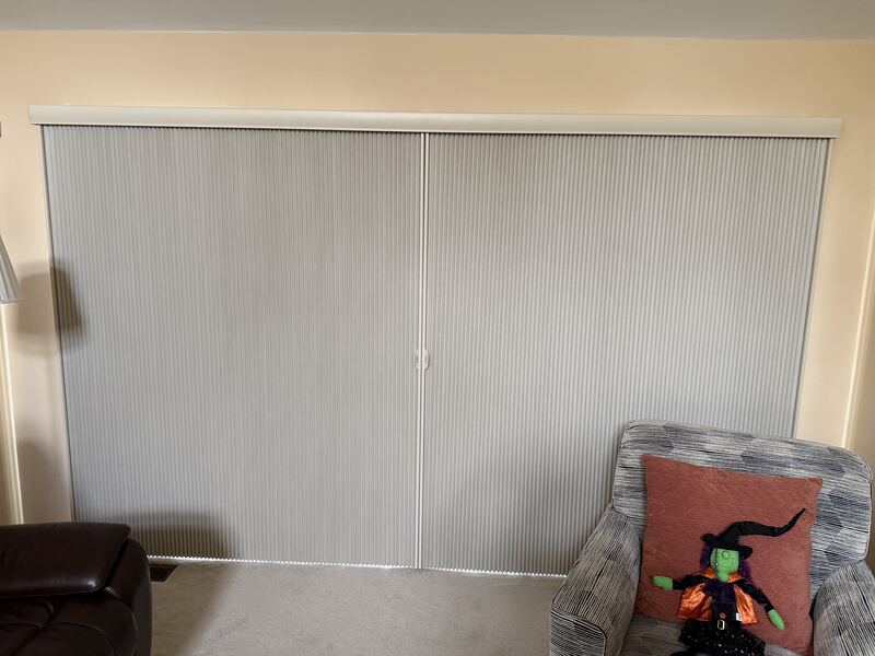 A wide cellular panel covering a full opening, cordless end to end.
